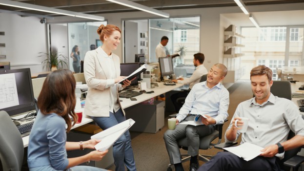 Casual Team Meeting In Open Office Discussing Business